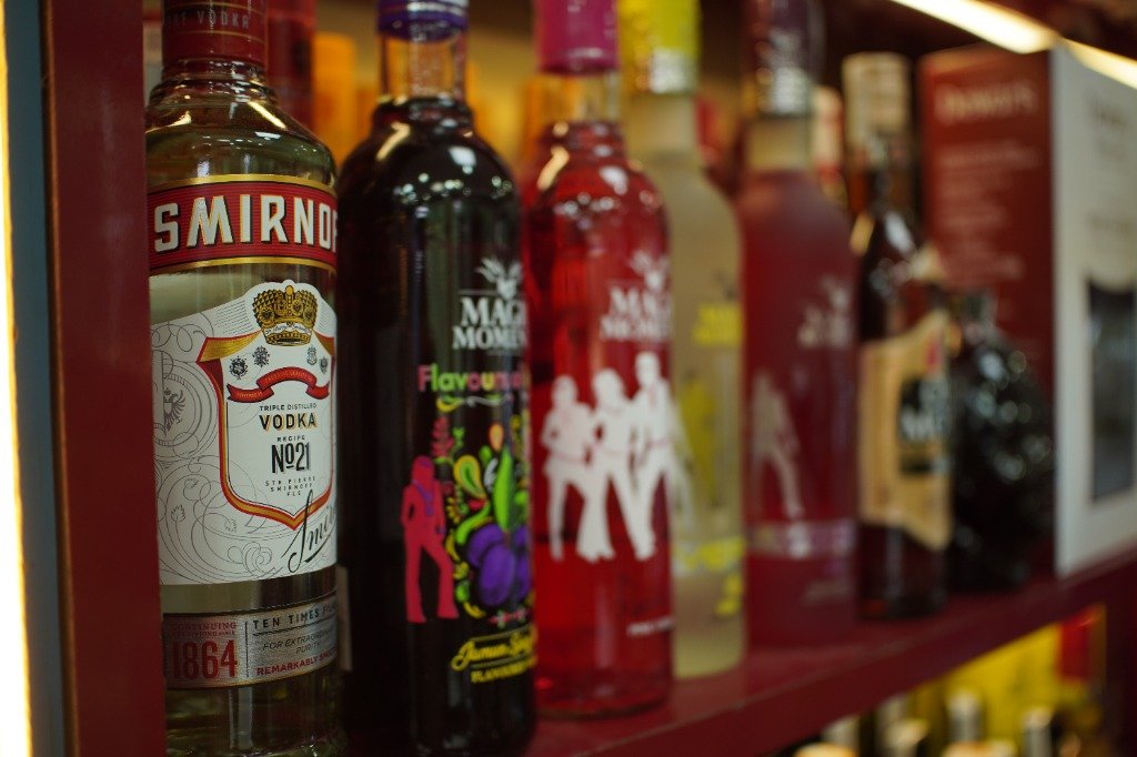 International and Indian wine and beverage bottles on shop shelf